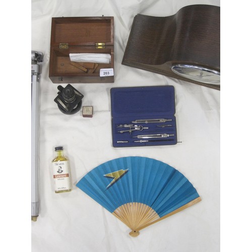 203 - A box of interesting items, to include a Staedtler draughting kit, BOAC Paper Fan, Microscope in woo... 