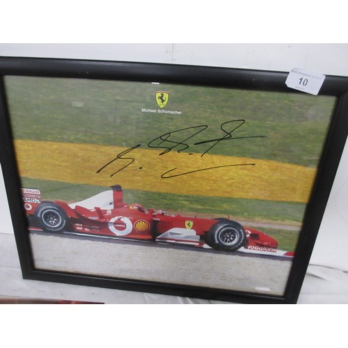 10 - A Michael Schumaker signed Ferrari picture, framed and glazed and in good order, and a number of lar... 