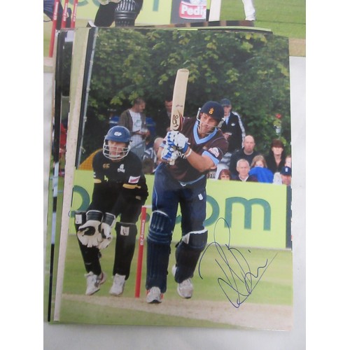 13 - A large box containing a quantity of signed photographs of cricketers