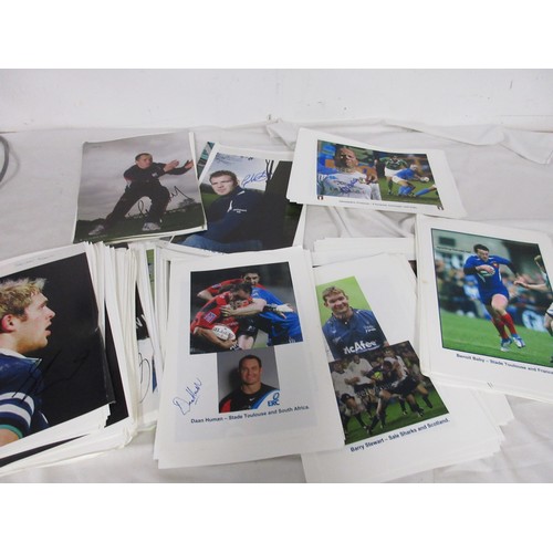 16 - A pile of photographs signed by Rugby stars