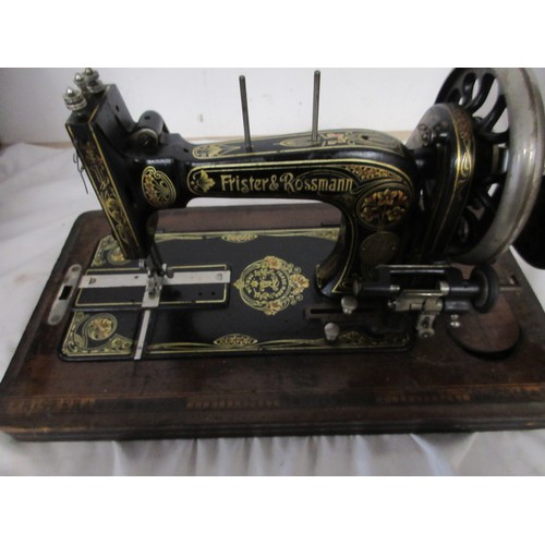 132 - A vintage wooden cased sewing machine made by Frister and Rossman.