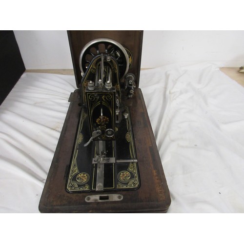 132 - A vintage wooden cased sewing machine made by Frister and Rossman.