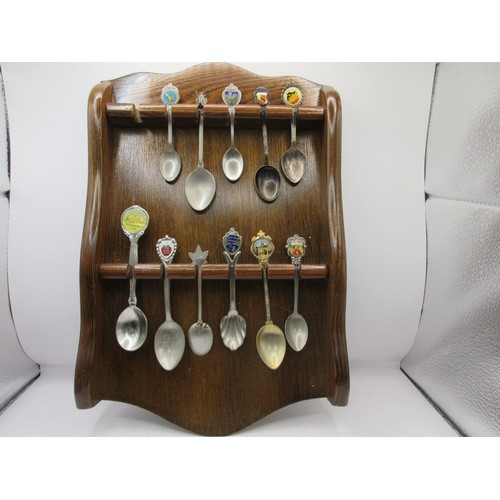 152 - A collection of teaspoons in wall-mounting racks