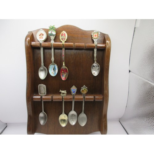 152 - A collection of teaspoons in wall-mounting racks