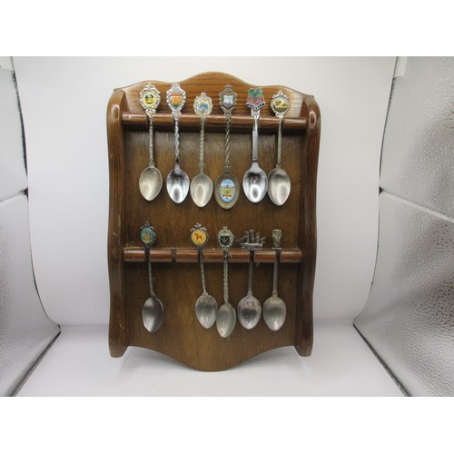 152 - A collection of teaspoons in wall-mounting racks