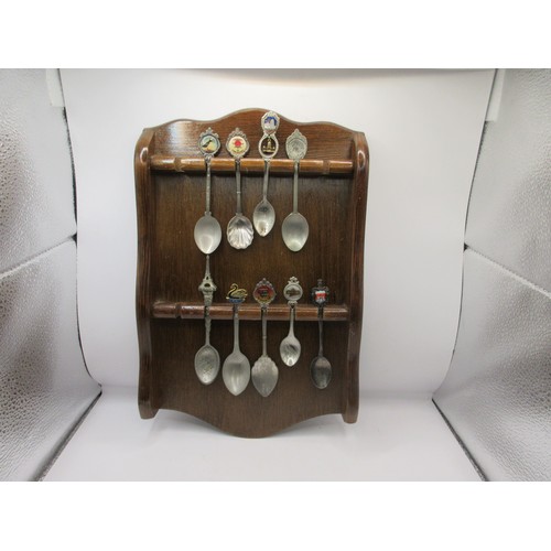 152 - A collection of teaspoons in wall-mounting racks