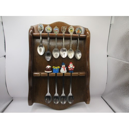 152 - A collection of teaspoons in wall-mounting racks