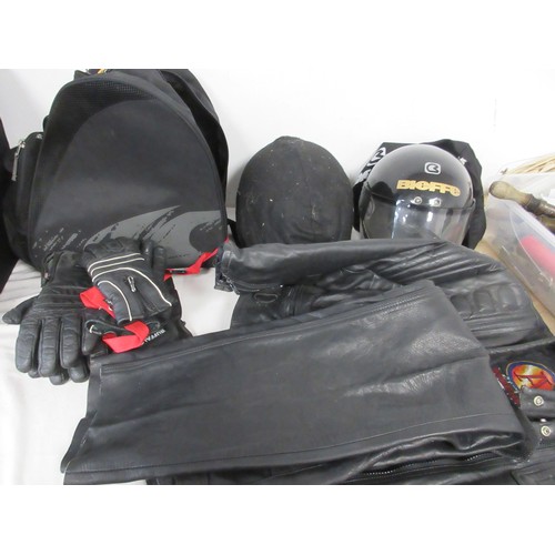 161 - A pair of motorcycle crash helmets in slip covers, plus a leather jacket etc