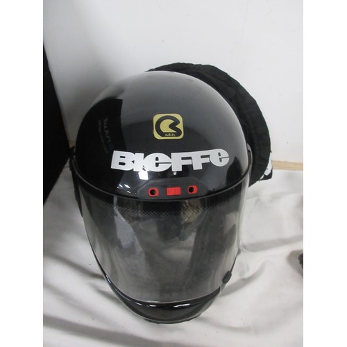 161 - A pair of motorcycle crash helmets in slip covers, plus a leather jacket etc