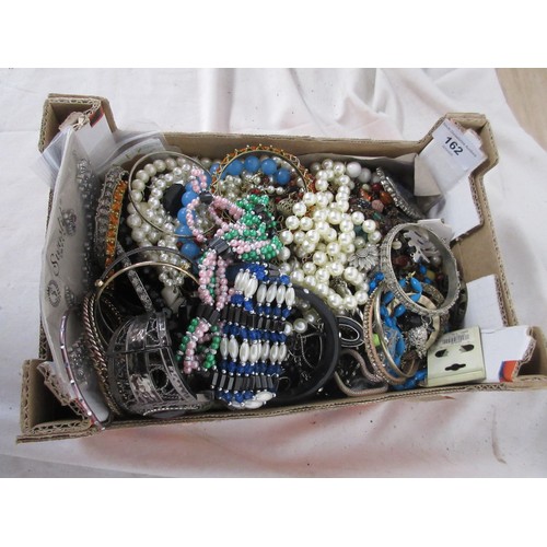 162 - An assortment of costume jewellery, bangles, necklaces, etc,  contained in a small cardboard tray