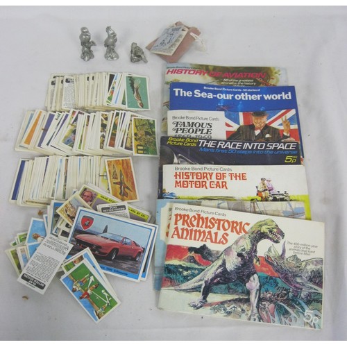 145 - A tub of Brooke Bond tea cards, some loose and some in books, together with a specimen of rock cryst... 