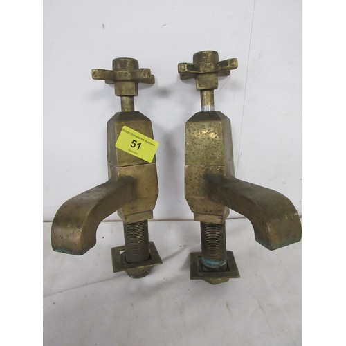 51 - A pair of early 20th century very heavy brass taps in apparent good order