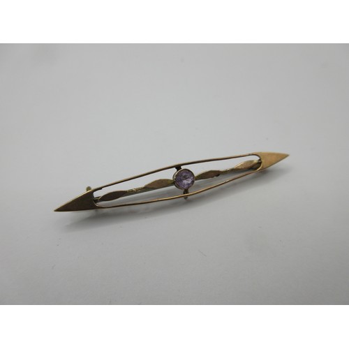 57 - A yellow metal bar brooch marked 9 carat to reverse set with an amethyst, with base metal pin, appro... 