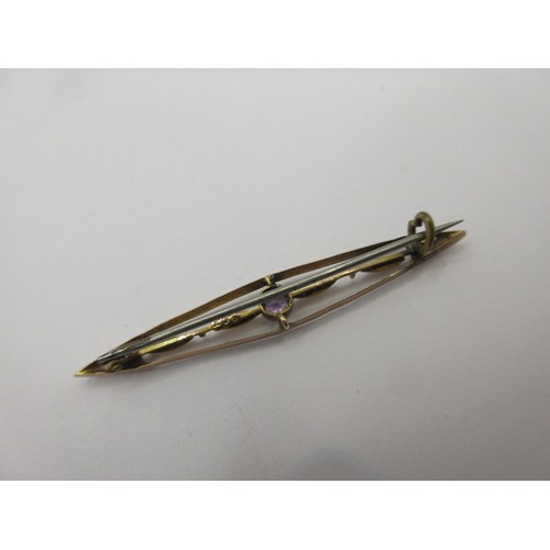 57 - A yellow metal bar brooch marked 9 carat to reverse set with an amethyst, with base metal pin, appro... 