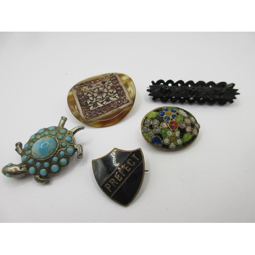 59 - A small selection of costume jewellery comprising a possibly jet brooch, a tortoiseshell brooch with... 