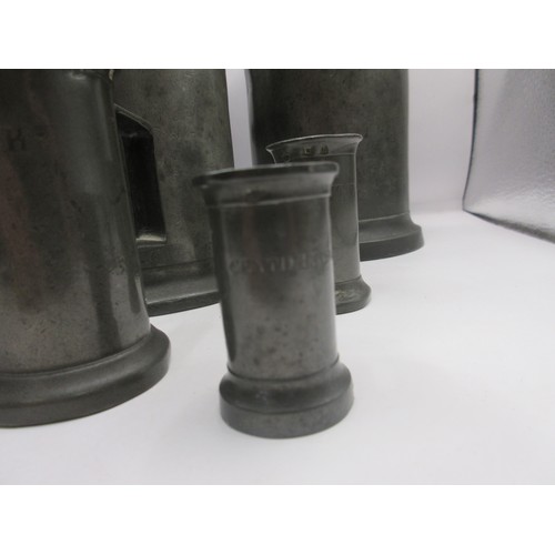 25 - A heavy set of 7 French graduated pewter measures of some age, marked for Litre down to centilitre, ... 