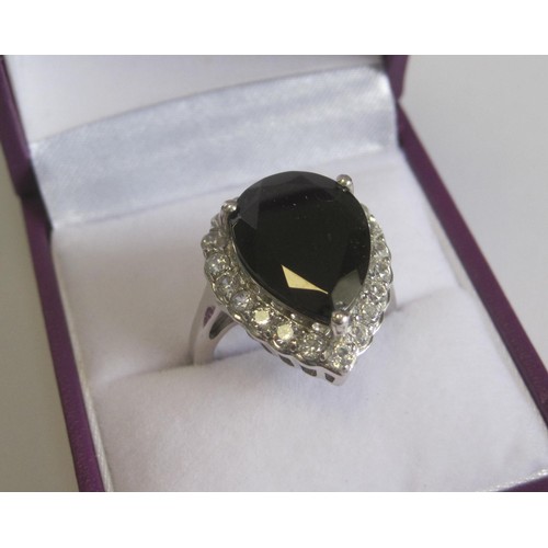 49 - A 925 silver dress ring set with a dark smoky pear-shape stone, with a border of white faux stones, ... 