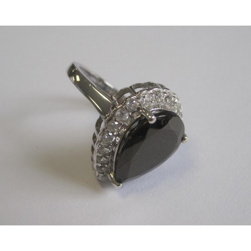 49 - A 925 silver dress ring set with a dark smoky pear-shape stone, with a border of white faux stones, ... 