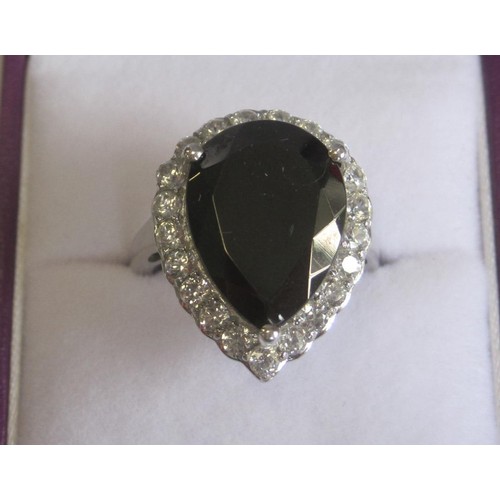 49 - A 925 silver dress ring set with a dark smoky pear-shape stone, with a border of white faux stones, ... 