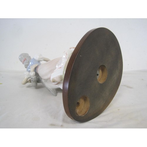 154 - A porcelain lamp base modelled as lady and gentleman dancing, on oval mahogany stand drilled for lig... 