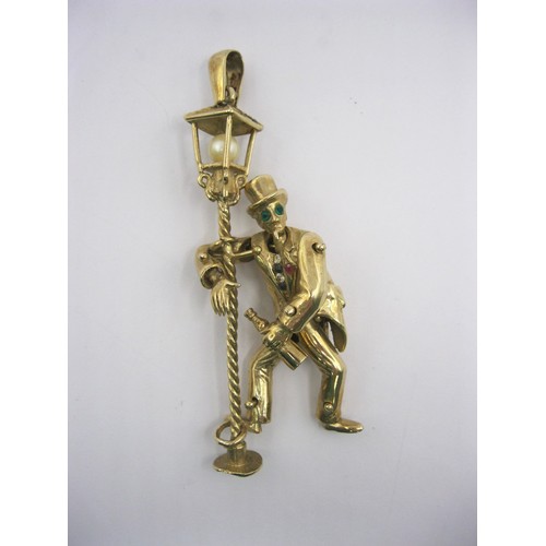 4 - A large 9 carat gold pendant modelled as an articulated drunken man figure supporting himself on a l... 