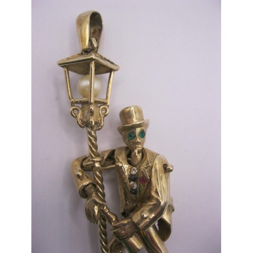 4 - A large 9 carat gold pendant modelled as an articulated drunken man figure supporting himself on a l... 