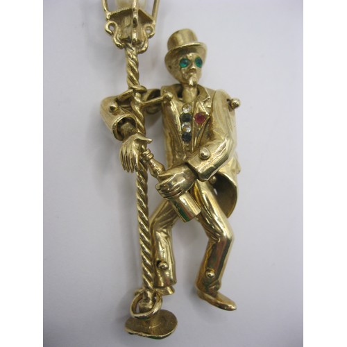 4 - A large 9 carat gold pendant modelled as an articulated drunken man figure supporting himself on a l... 