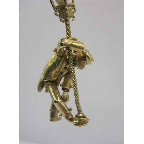 4 - A large 9 carat gold pendant modelled as an articulated drunken man figure supporting himself on a l... 