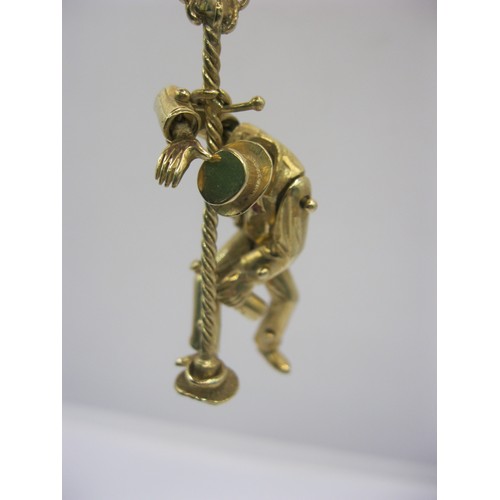 4 - A large 9 carat gold pendant modelled as an articulated drunken man figure supporting himself on a l... 