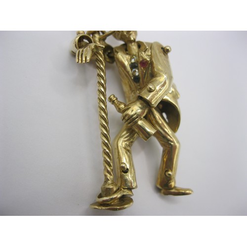 4 - A large 9 carat gold pendant modelled as an articulated drunken man figure supporting himself on a l... 