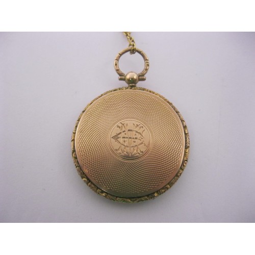 6 - A 9 carat gold circular locket pendant on chain. The locket with British hallmarks within, gross wei... 