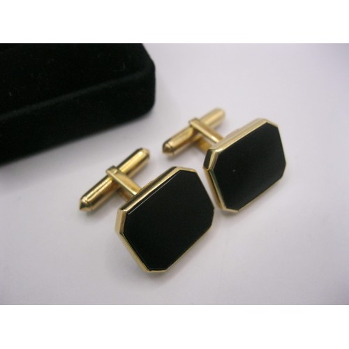 7 - A pair of yellow metal cufflinks set with polished black faces, rectangular with canted corners, one... 