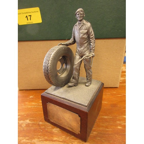 17 - A vintage figure of a military mechanic holding a wheel and tools mounted on a black presentation pl... 