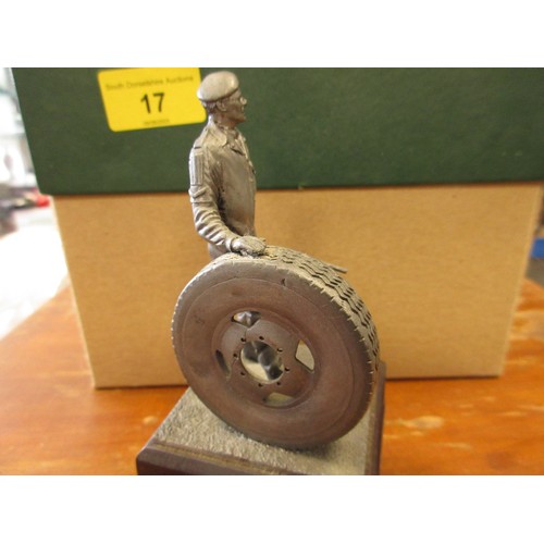 17 - A vintage figure of a military mechanic holding a wheel and tools mounted on a black presentation pl... 