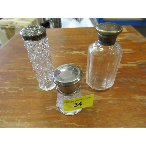 34 - Three dressing table bottles. (1) A small dressing table bottle with silver lid, height 58mm, marks ... 