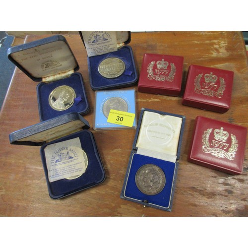 30 - A bronze Rhodesian Independence Medal, together with other cased commemorative medals and crowns, in... 