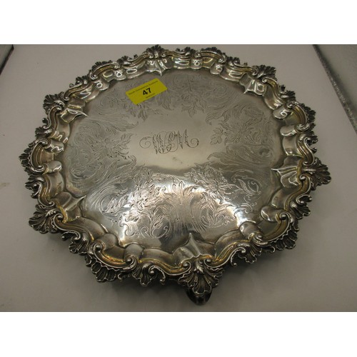 47 - A substantial circular sterling silver salver on scrolled feet with scrolled acanthus rim, script in... 