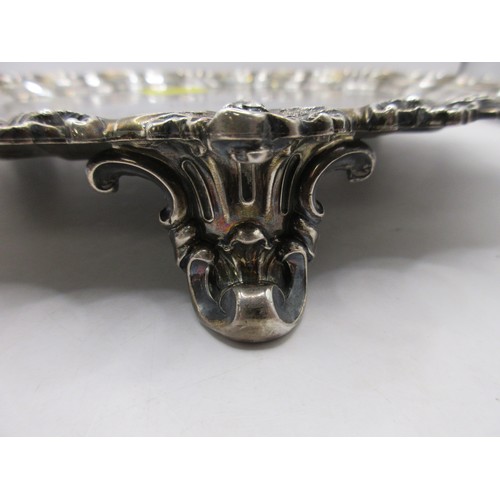 47 - A substantial circular sterling silver salver on scrolled feet with scrolled acanthus rim, script in... 