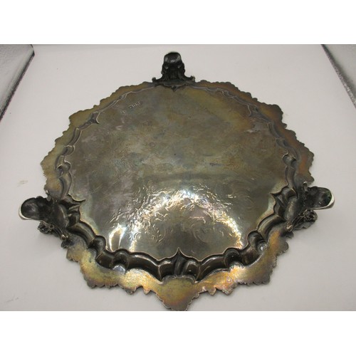 47 - A substantial circular sterling silver salver on scrolled feet with scrolled acanthus rim, script in... 