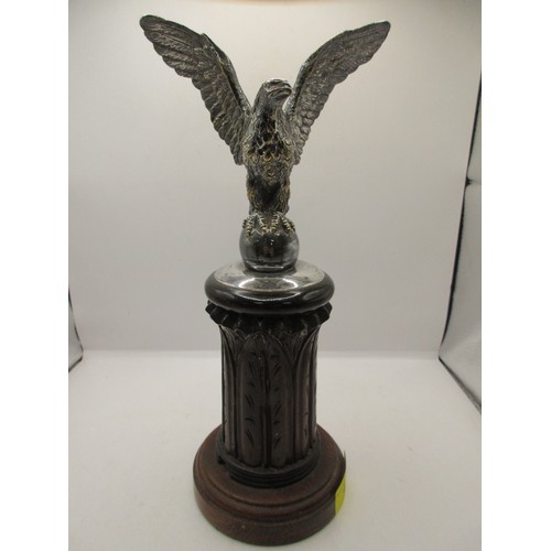 48 - AN imposing antique car bonnet mascot in the form of an eagle with wings spread atop an egg, in silv... 