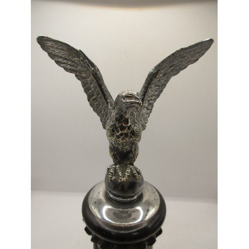 48 - AN imposing antique car bonnet mascot in the form of an eagle with wings spread atop an egg, in silv... 