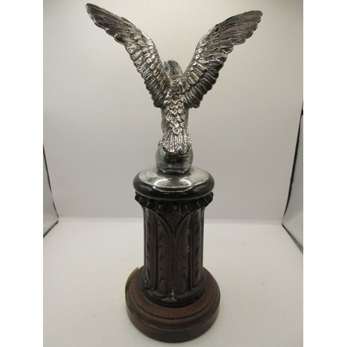 48 - AN imposing antique car bonnet mascot in the form of an eagle with wings spread atop an egg, in silv... 