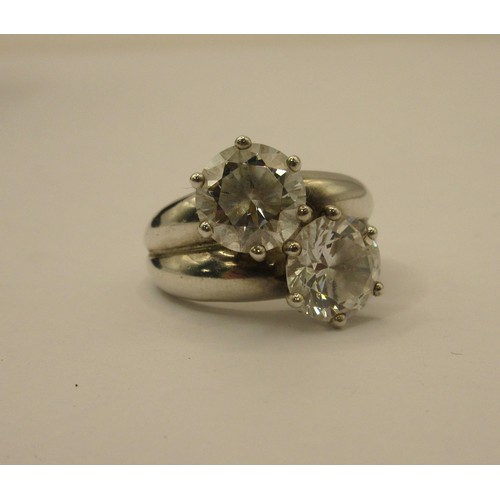 90 - A 925 silver dress ring set with two white stones, ring size N/O, stamped 925 DOCZ, with a black pre... 