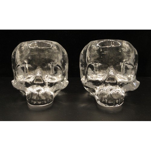 119 - Two Kosta Boda skull tea light holders designed by Ludvig Lofgren, with original boxes and leaflets