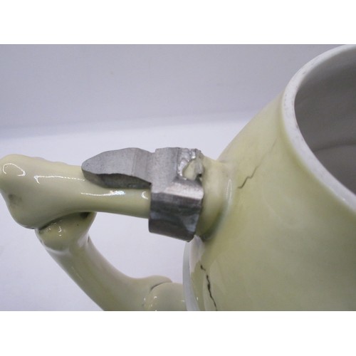 120 - Two German pottery skull tankards or beer steins. One with a serpent handle, the other with a top ha... 