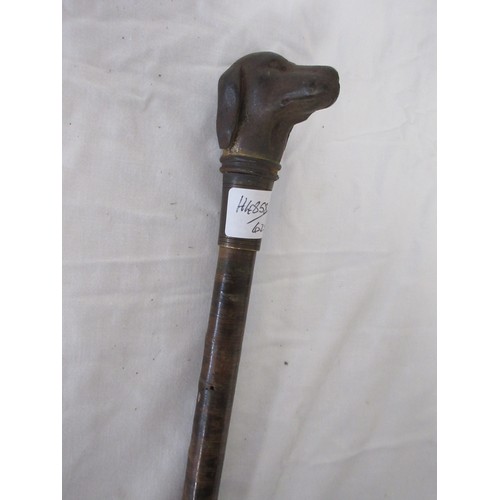 192 - A skull crusher walking cane covered in leather washers, with heavy cast iron dog head handle. Overa... 