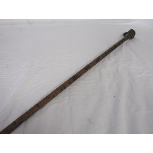 192 - A skull crusher walking cane covered in leather washers, with heavy cast iron dog head handle. Overa... 