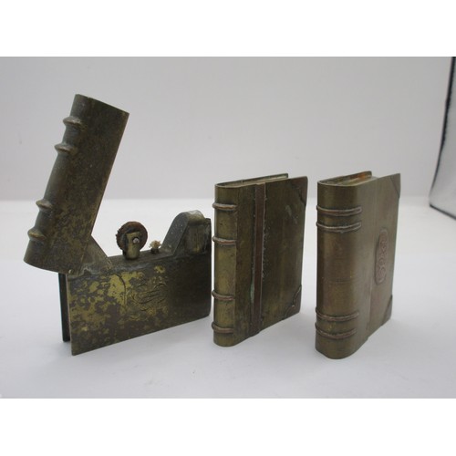 196 - Three WW1 trench art petrol lighters in the form of miniature books, made from pieces of scrap brass... 