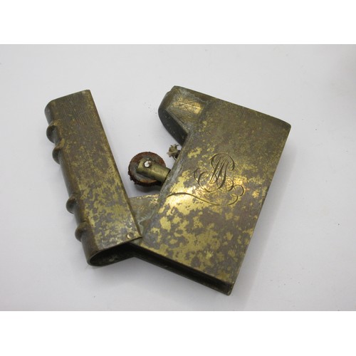 196 - Three WW1 trench art petrol lighters in the form of miniature books, made from pieces of scrap brass... 