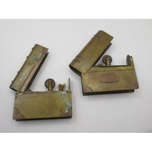 196 - Three WW1 trench art petrol lighters in the form of miniature books, made from pieces of scrap brass... 